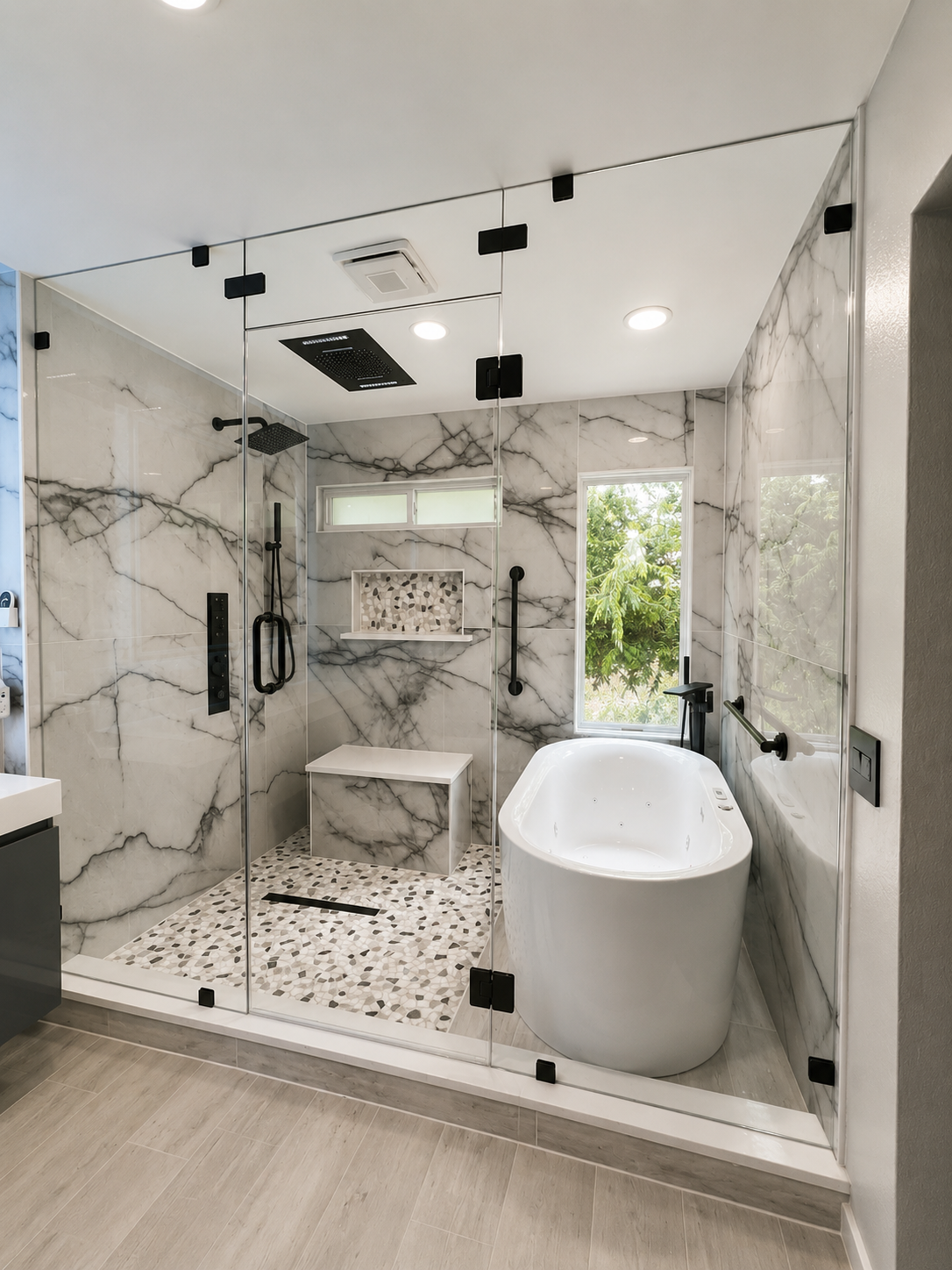 Modern bathroom with gray vanity, herringbone tile shower, and frameless glass enclosure