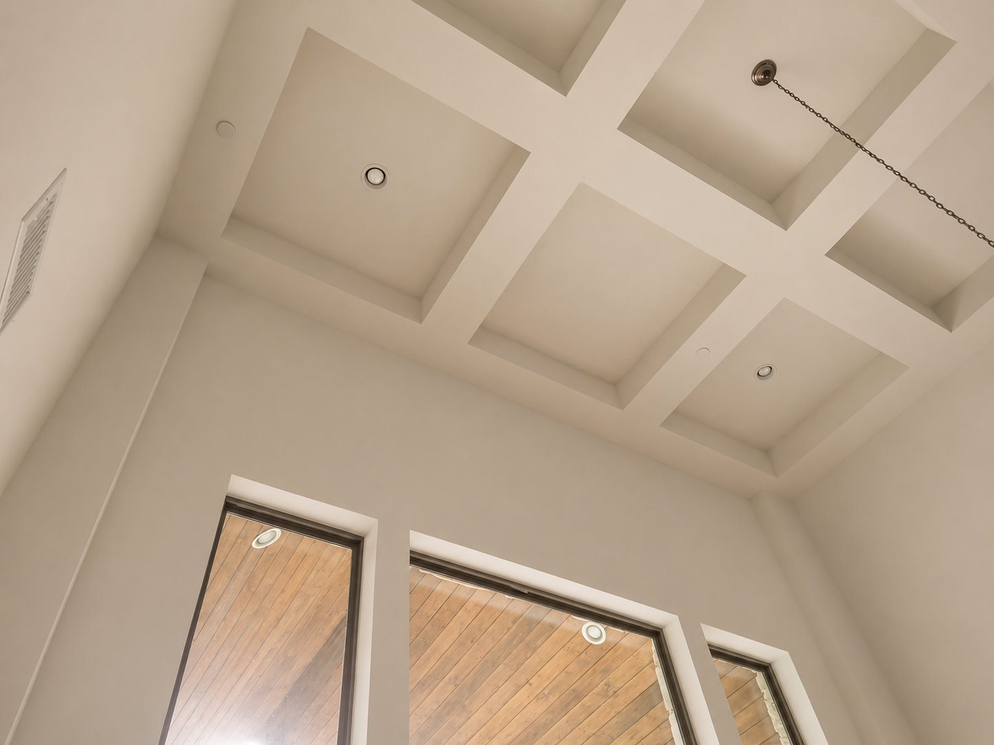 Custom ceiling design with recessed lighting and architectural details