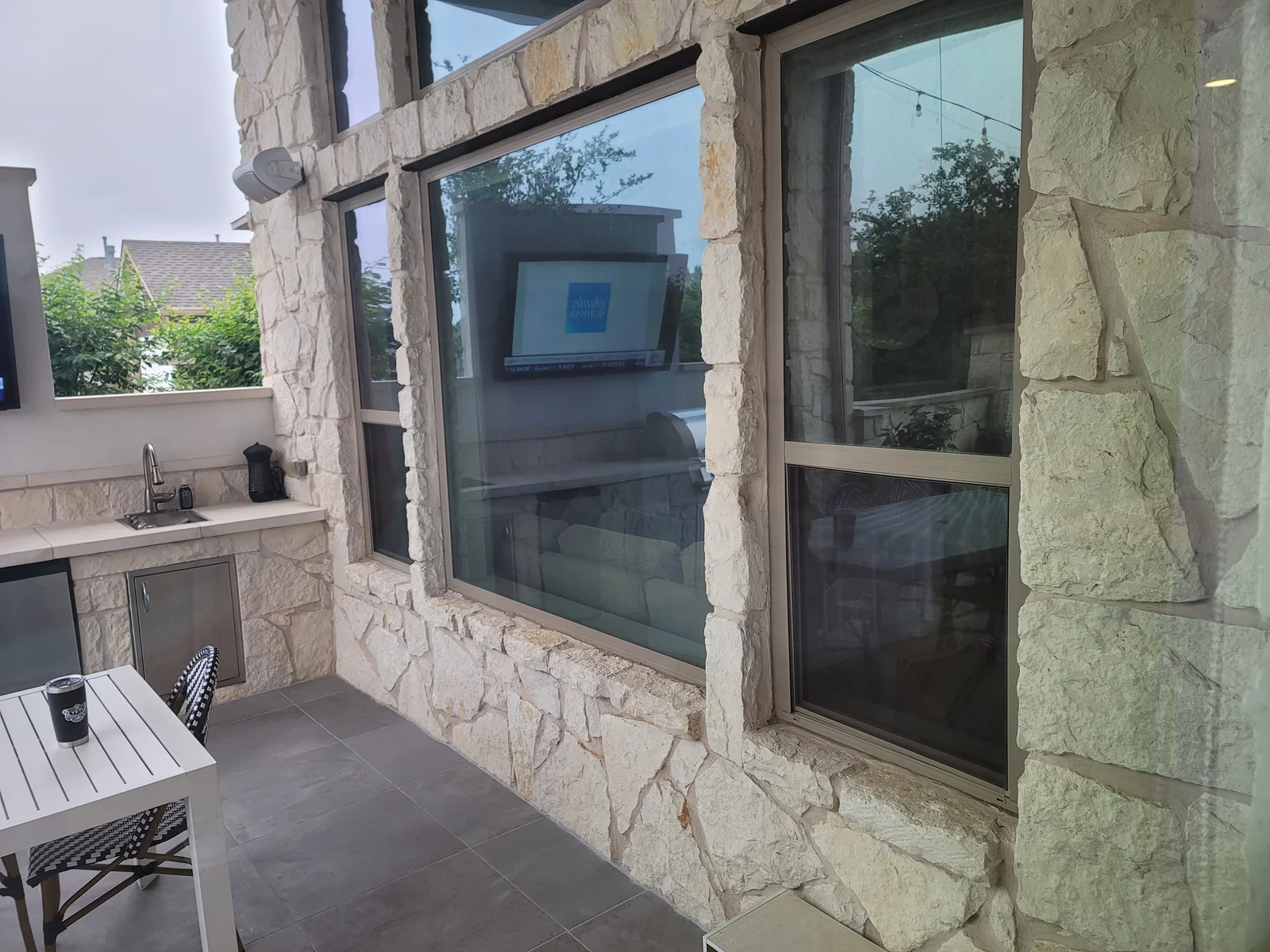 Exterior home construction with stone facade and large windows